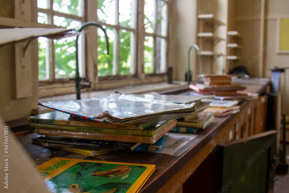 Abandoned School Building - taps and textbooks in a science lab Abandoned School Building - taps and textbooks in a science lab