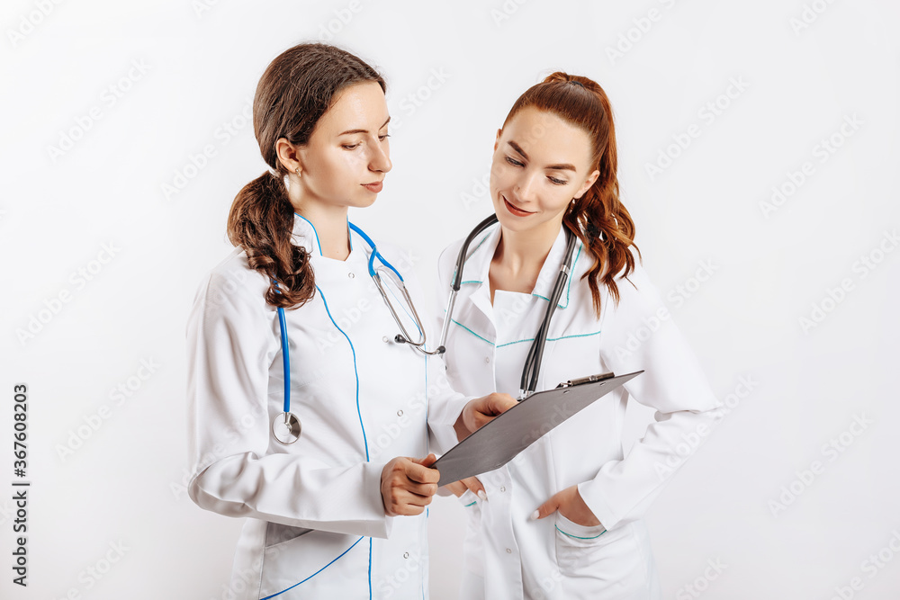 Medical documents. Two doctors with stethoscope at hospital. Nurse hold patient medical chart. Information data. Therapist in uniform. Medical history prescription. Woman work at clinic. Medical documents. Two doctors with stethoscope at hospital. Nurse hold patient medical chart. Information data. Therapist in uniform. Medical history prescription. Woman work at clinic.