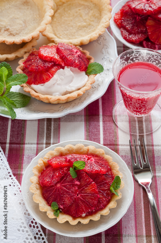 Blood Orange Tartlets. Homemade Pie Crust Filled with Whipped Cream and Fresh Citrus