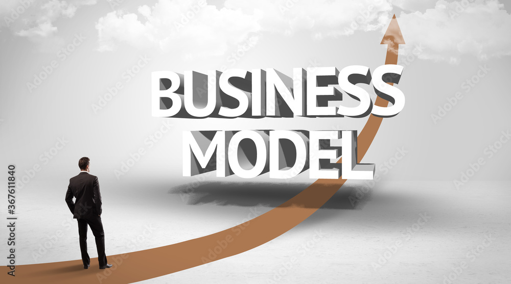 Rear view of a businessman standing in front of BUSINESS MODEL inscription, successful business concept Rear view of a businessman standing in front of BUSINESS MODEL inscription, successful business concept