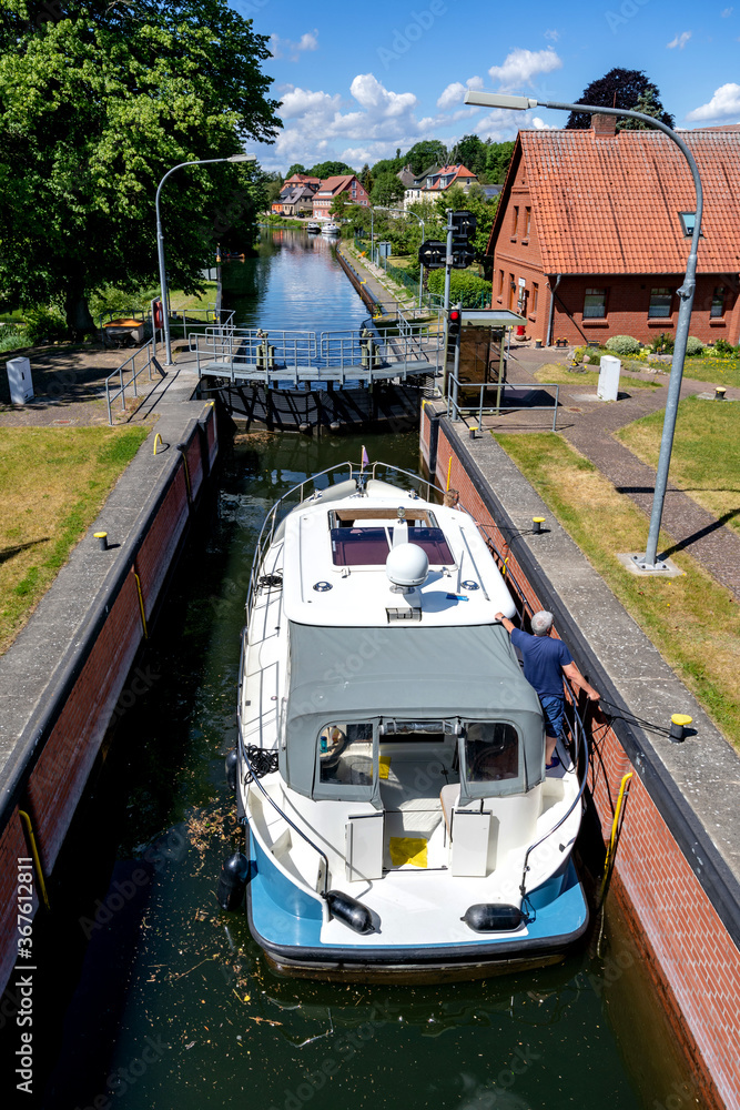Naklejka premium motorboat in the river Elde lock in Plau am See, Germany