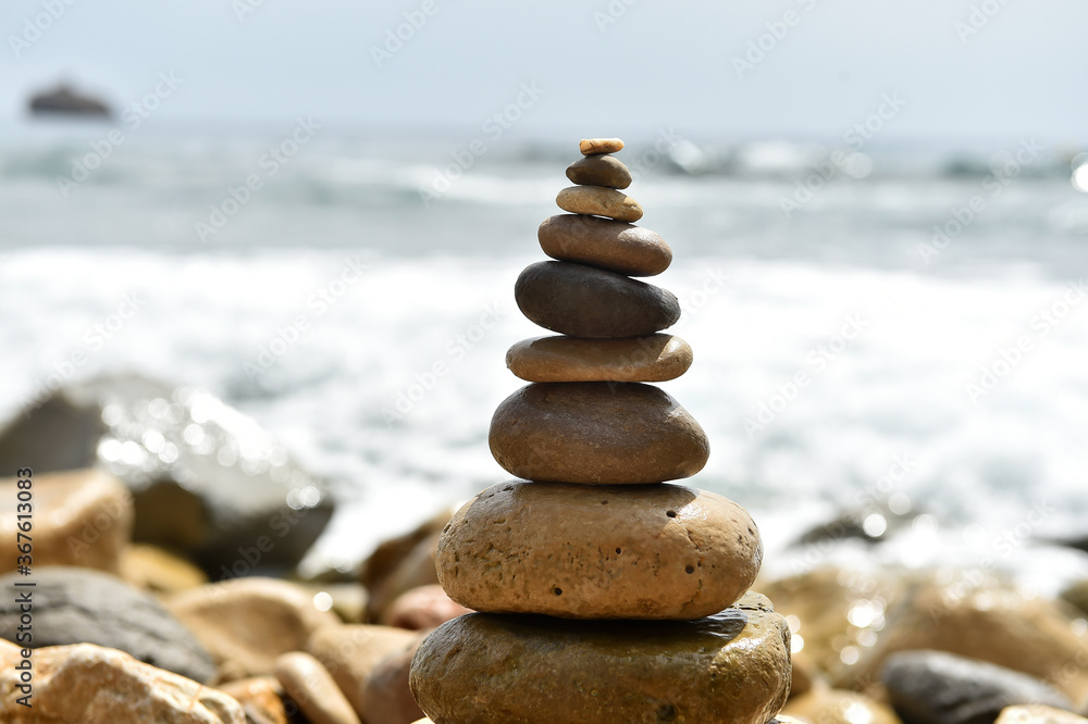 Fototapeta premium a tower of stones on the beach