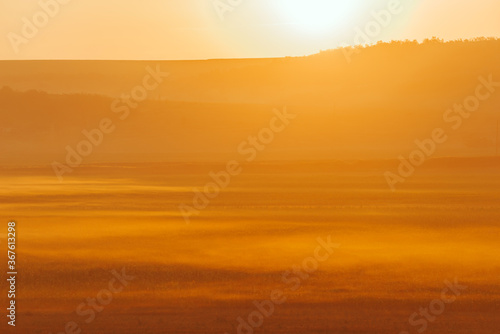 Amazing photo of foggy golden morning at sunrise, beautiful and warm landscape.