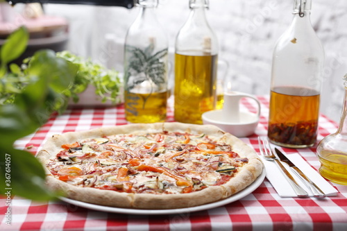  Pizza with grilled vegetables. Italian cuisine.Traditional Italian pizza. Suggestion to serve a dish. Food background.