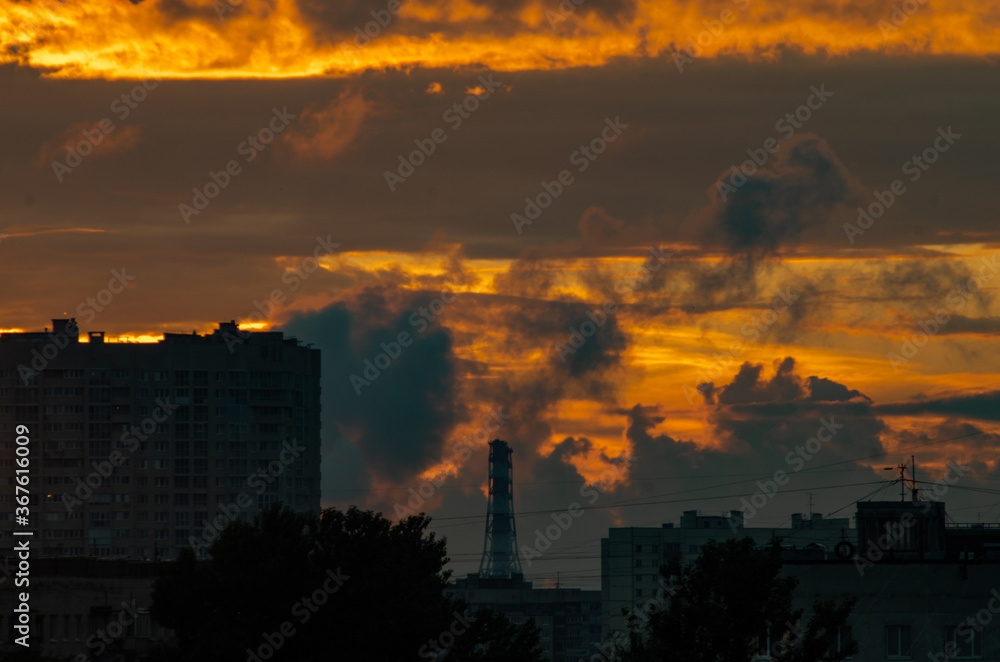 Fototapeta premium sunset over the city with storm clouds
