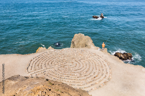 Labyrinth with lonely fisherman in San Francisco secret spot.