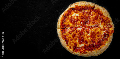 sliced Pizza with Mozzarella cheese, Tomatoes, pepper, Spices. Italian pizza. Pizza Margherita or Margarita on Dark grey black slate background
