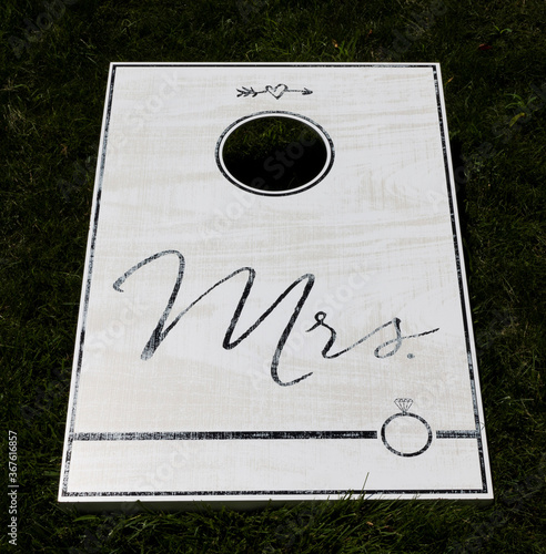 White cornhole game with Mrs written in black text photo