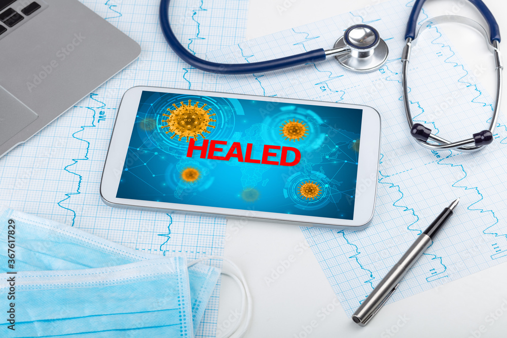 Close-up view of a tablet pc with HEALED inscription, microbiology concept Close-up view of a tablet pc with HEALED inscription, microbiology concept