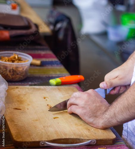 close up of man cooking in the kitchen in a restaurant 