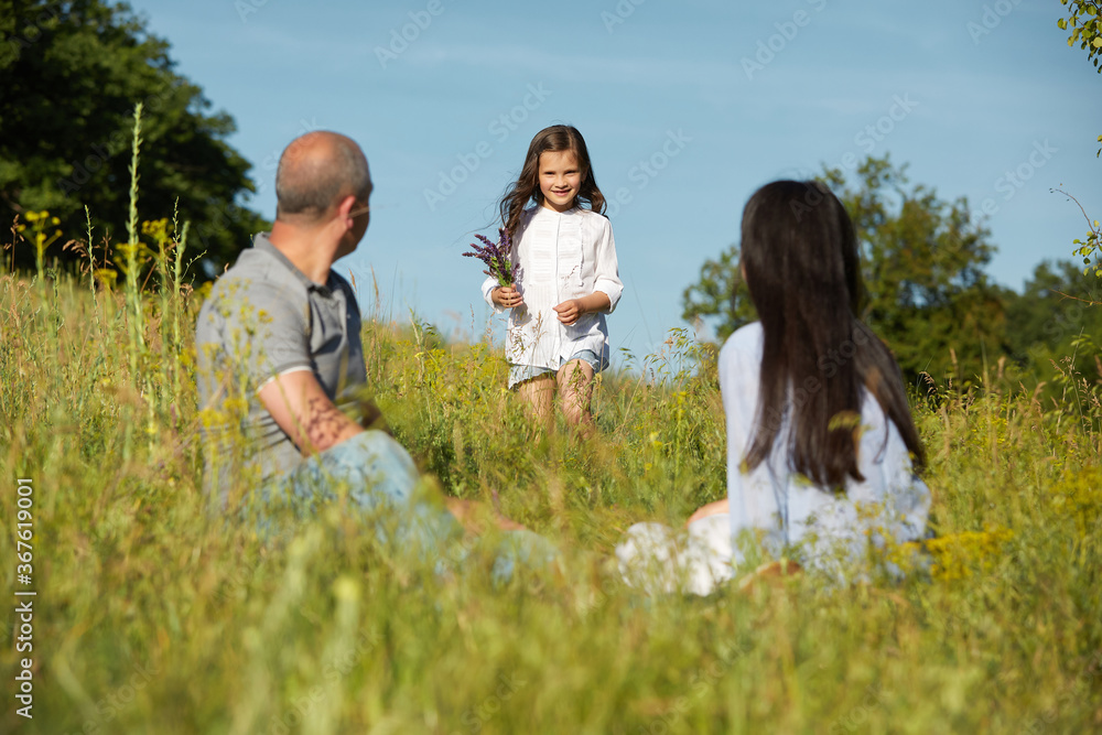 happy family in nature in sunny summer day