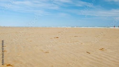Walking along the incredible Camber Sands beach, in East Sussex, England, UK famous for its large bay, extensive dunes and fine sand