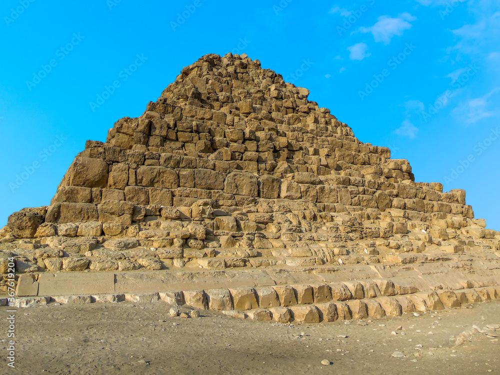 A step pyramid forming part of the complex at Giza, Egypt in summer