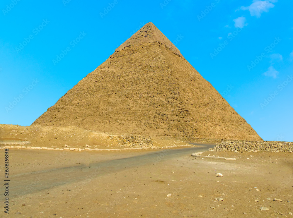The Great Pyramid at Giza, Egypt stands out from a blue sky in summer The Great Pyramid at Giza, Egypt stands out from a blue sky in summer