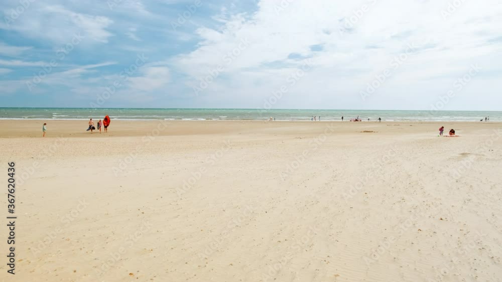 Walking along the incredible Camber Sands beach, in East Sussex, England, UK famous for its large bay, extensive dunes and fine sand Walking along the incredible Camber Sands beach, in East Sussex, England, UK famous for its large bay, extensive dunes and fine sand