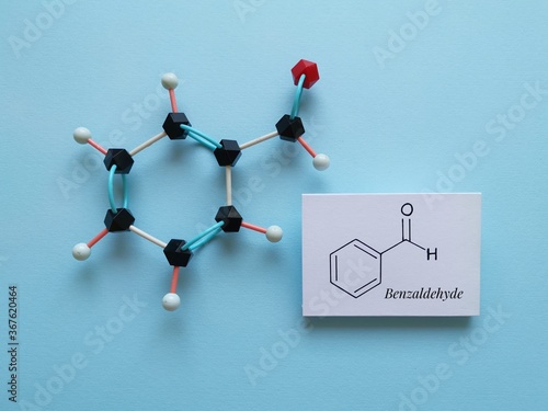 Molecular structure model and structural chemical formula of benzaldehyde. It is an aromatic aldehyde and one of the most industrially useful; a colorless liquid with a characteristic almond-like odor