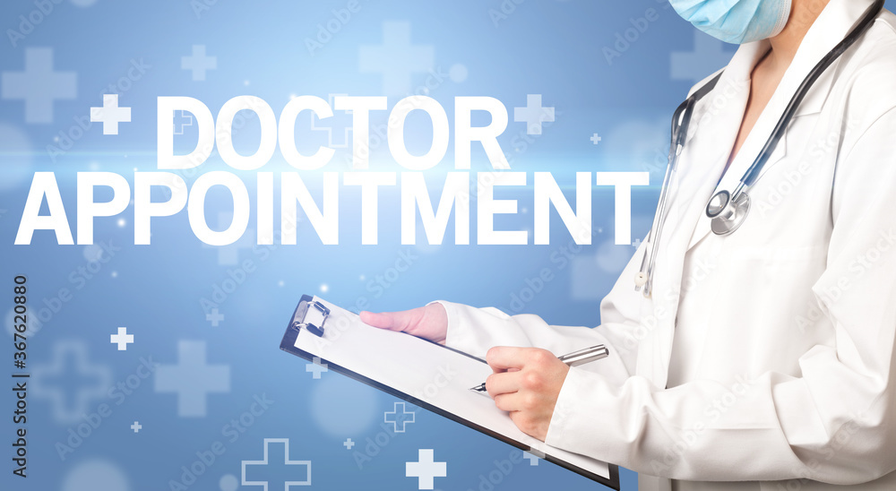 doctor writes notes on the clipboard with DOCTOR APPOINTMENT inscription, first aid concept doctor writes notes on the clipboard with DOCTOR APPOINTMENT inscription, first aid concept
