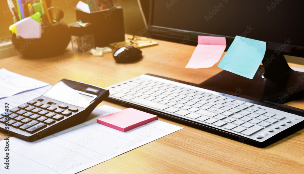 Business documents on an office desk with a printer and computer as a business concept of a workspace. With cloud exposure Business documents on an office desk with a printer and computer as a business concept of a workspace. With cloud exposure