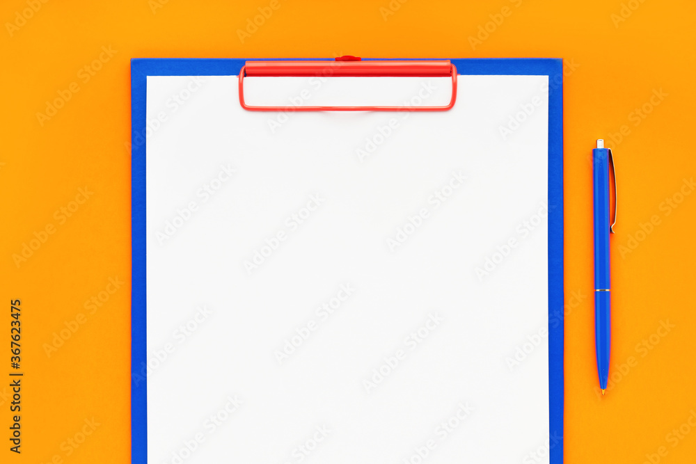 Blank clipboard mockup and blue pen on orange color background. Top view, copy space. Back to school, deadline, morning concept. Blank clipboard mockup and blue pen on orange color background. Top view, copy space. Back to school, deadline, morning concept.