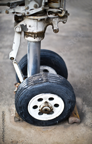 the front wheel of an old airplane. landing gear.