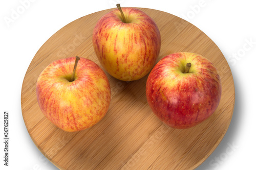 Fresh apples selected under wooden board.