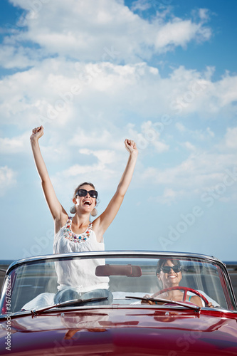 Happy Women Driving Rented Convertible Car For Vacations © Diego Cervo