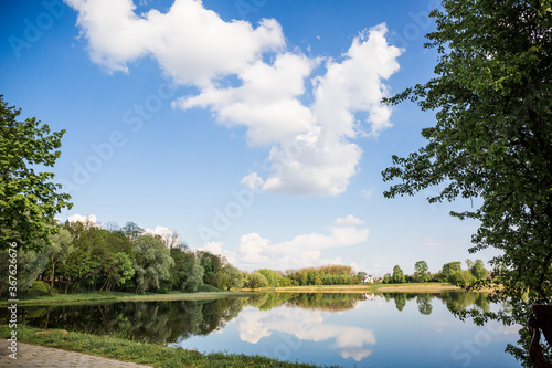 Beautiful view of the lake with a mirror reflection, in clear sunny weather. Belarus. Park Nesvizh. Historical attraction.