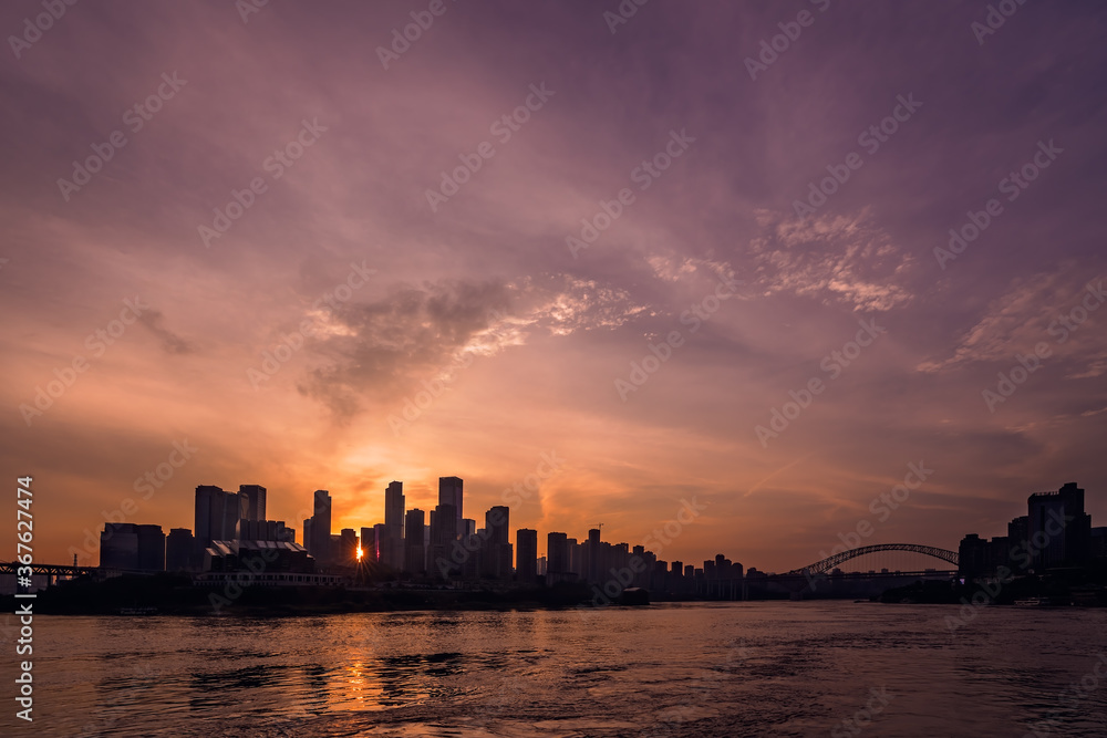 Silhouettes of buildings surrounded by the Yangtze river under the sunlight during the sunset in Chongqing Silhouettes of buildings surrounded by the Yangtze river under the sunlight during the sunset in Chongqing