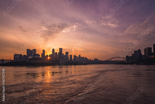 Silhouettes of buildings surrounded by the Yangtze river under the sunlight during the sunset in Chongqing © Pav-Pro Photography 