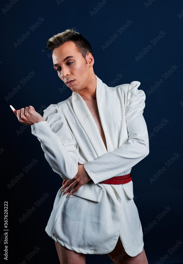 a transgender model with long nails and a dark blue background a transgender model with long nails and a dark blue background