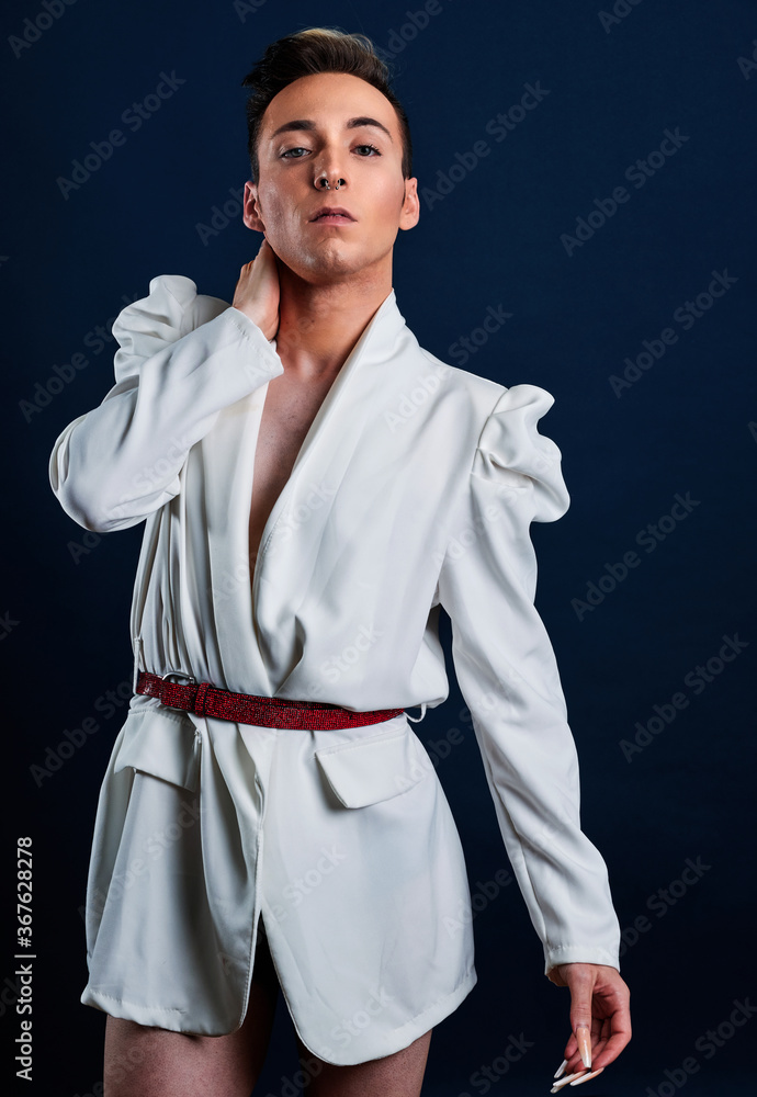 a transgender model with long nails and a dark blue background a transgender model with long nails and a dark blue background