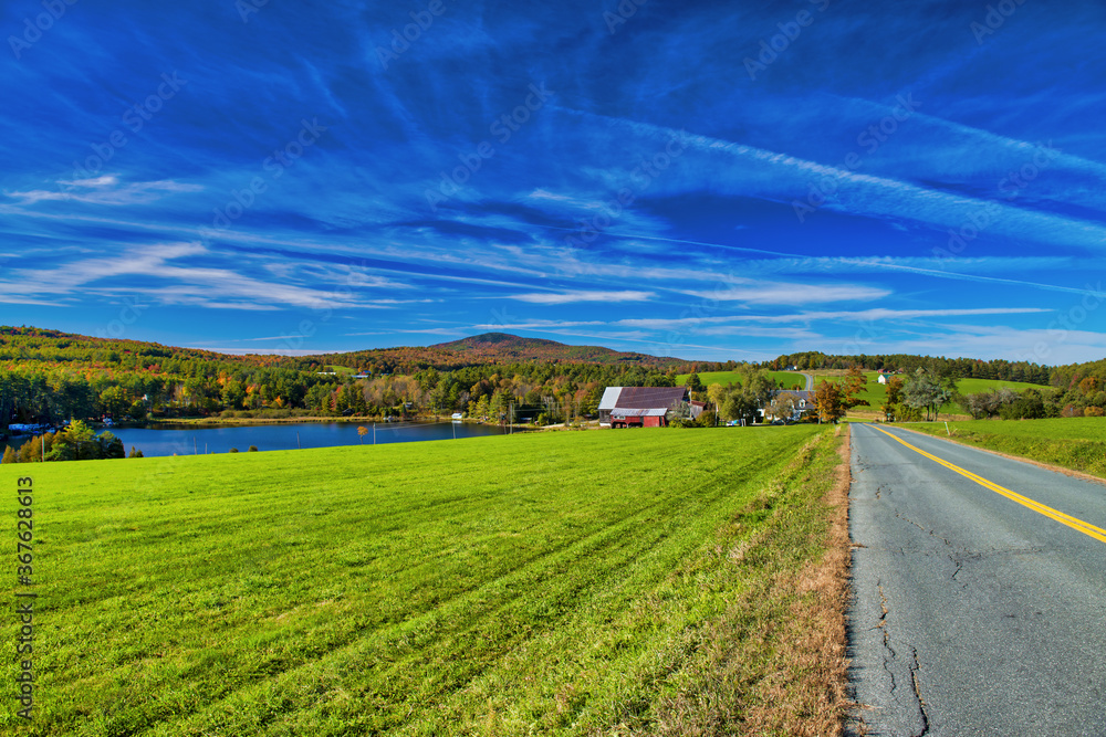 Obraz premium Road across New England countryside in foliage season, USA