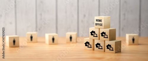 cubes showing a message HOME OFFICE and house symbols on wooden background