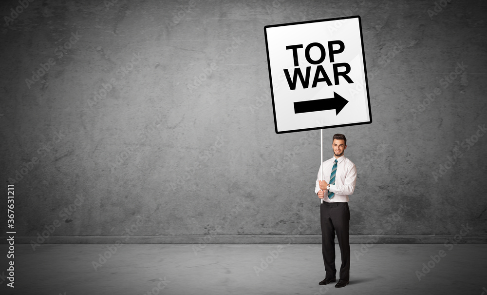 business person holding a traffic sign with TOP WAR inscription, new idea concept business person holding a traffic sign with TOP WAR inscription, new idea concept