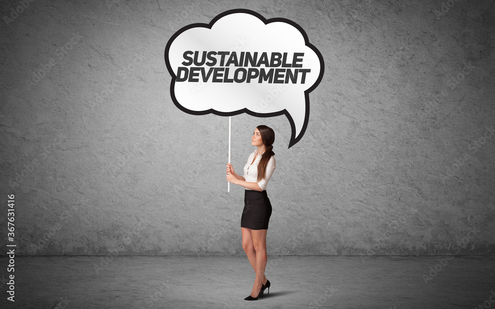 Young business person in casual holding road sign with SUSTAINABLE DEVELOPMENT inscription, new business idea concept Young business person in casual holding road sign with SUSTAINABLE DEVELOPMENT inscription, new business idea concept