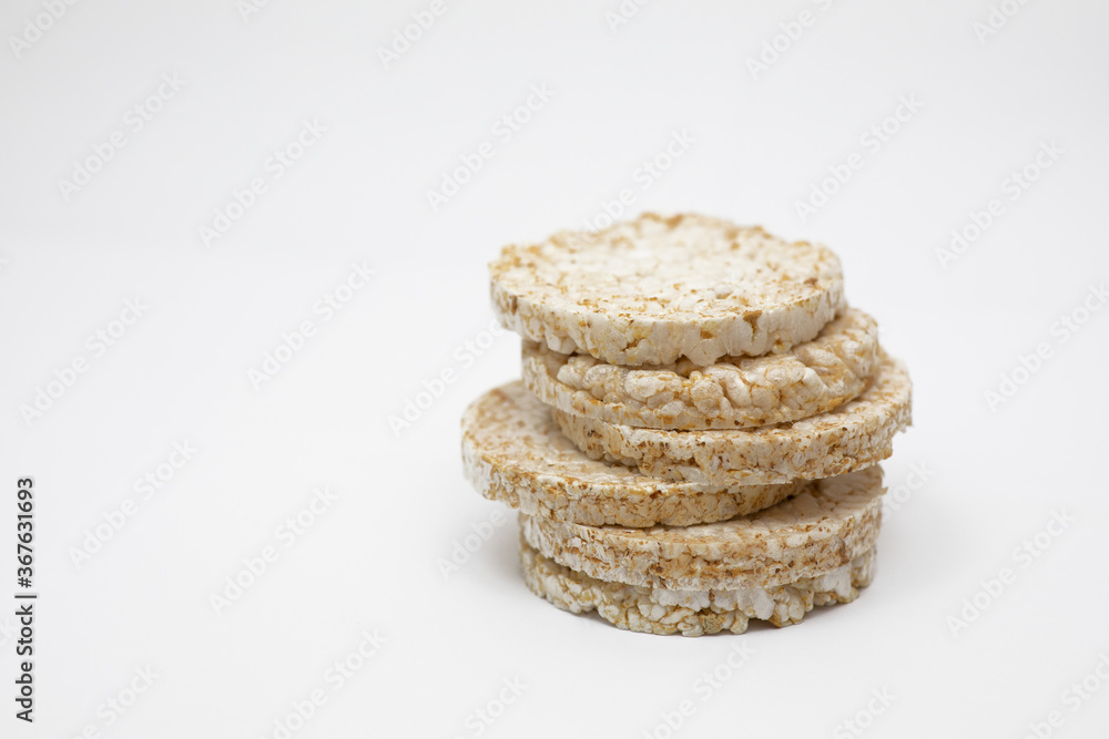 Six brown rice wafers on a white background