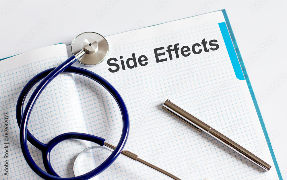 Paper with text SIDE EFFECTS on a table with stethoscope Paper with text SIDE EFFECTS on a table with stethoscope