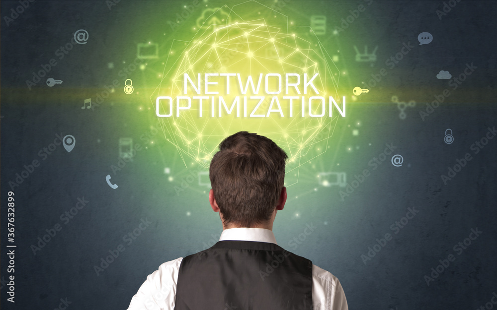 Rear view of a businessman with NETWORK OPTIMIZATION inscription, online security concept Rear view of a businessman with NETWORK OPTIMIZATION inscription, online security concept