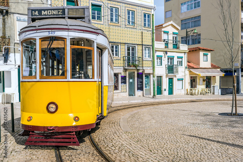 The yellow 28E tourist tram in the Graça neighbourhood of Lisbon, the capital of Portugal photo