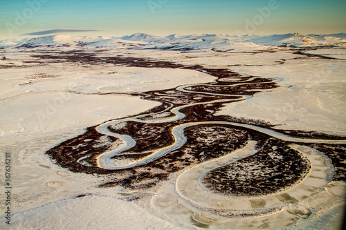 An aerial view of a  winding river on a cold winter morning near Nome, Alaska. photo