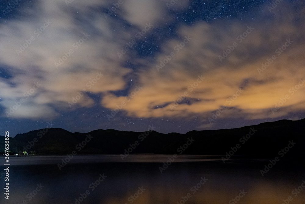 Night sky cloudy with stars view over Lagoon of Sete Cidades. São Miguel Island, Azores, Portugal.