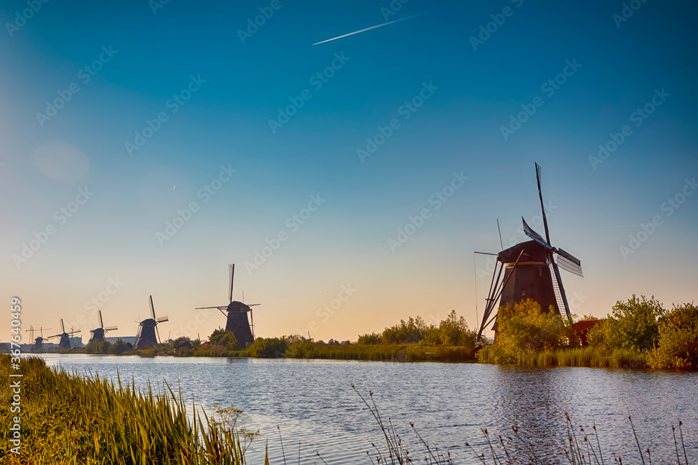 European Travel Ideas. Traditional Romantic Dutch Windmills in Kinderdijk Village in the Netherlands Before The Sunset.