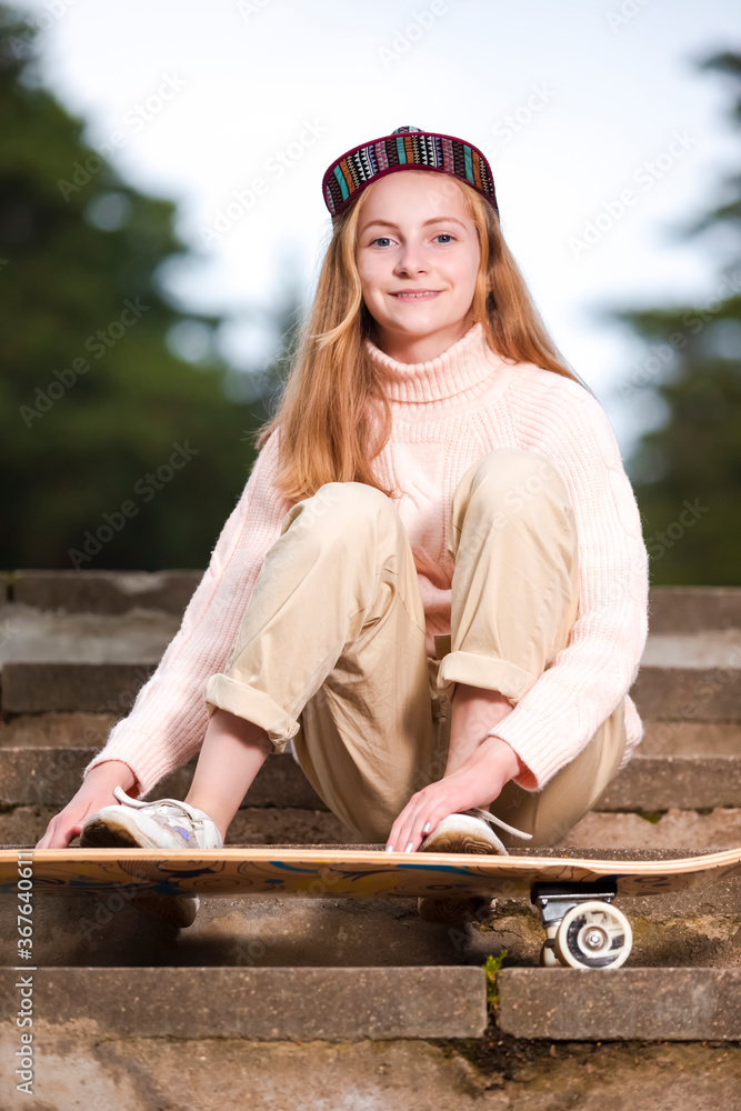 Teenager Lifestyle Concepts. natural portrait of Happy Caucasian Teenager Girl Posing With Longboard Outdoors On Stairs. Teenager Lifestyle Concepts. natural portrait of Happy Caucasian Teenager Girl Posing With Longboard Outdoors On Stairs.