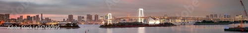 Tokyo Destinations. Famous Rainbow Bridge in Odaiba Island in Tokyo with Line of Skyscrapers in Background.