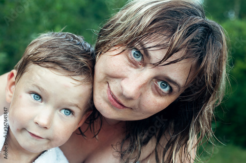 Close-up portrait of happy mother and her little son after bathing. © De Visu