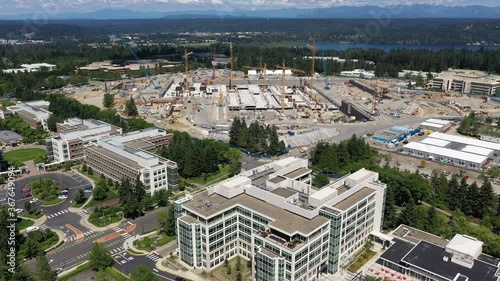 Drone footage of construction in Redmond, Washington at the Microsoft corporate headquarters with Lake Sammamish and the Cascade range as a backdrop photo