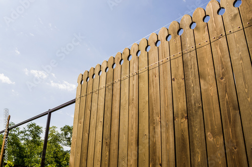 Installing a wooden fence on a dacha plot.