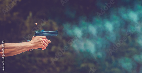 Obraz na płótnie Small puff of smoke coming from a handgun after being fired