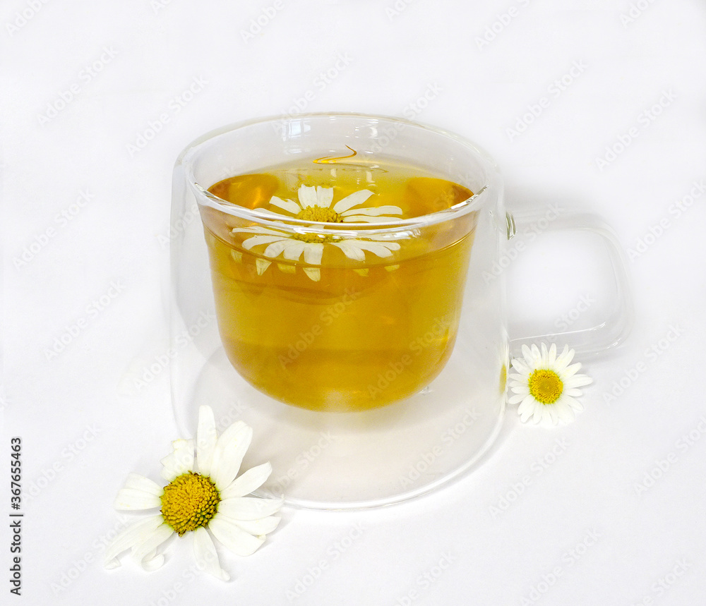 tea with chamomile in a glass cup on a white background, concept of ecology, medicinal tea, summer tea with chamomile in a glass cup on a white background, concept of ecology, medicinal tea, summer