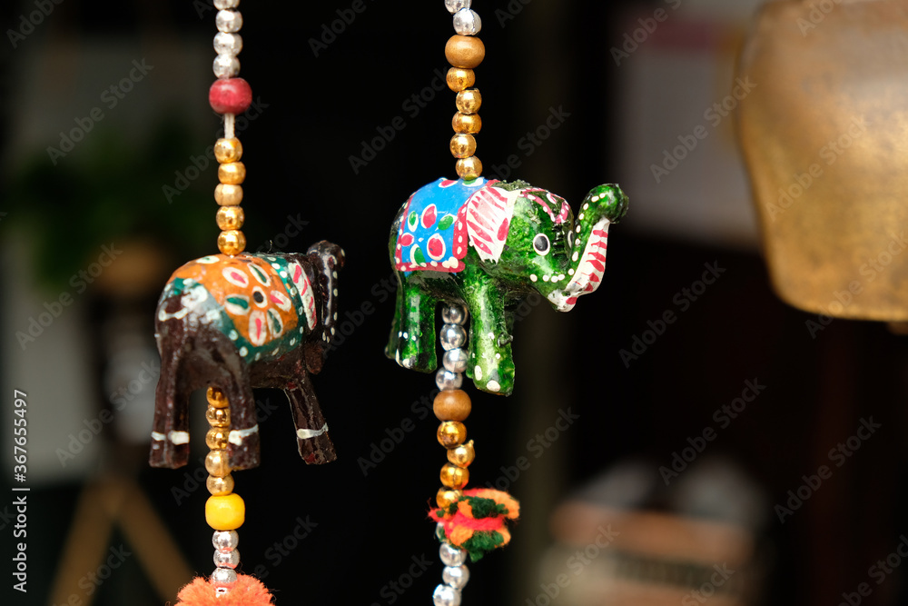 Decorative paper elephants, brown and green - symbols and signs of indian (hindu) and buddhist religions and tradition, low angle view. - obrazy, fototapety, plakaty 